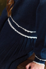 TARTINE ET CHOCOLAT LONG SLEEVE PLEATED DRESS WITH NECK BUTTONS AND WHITE TRIM